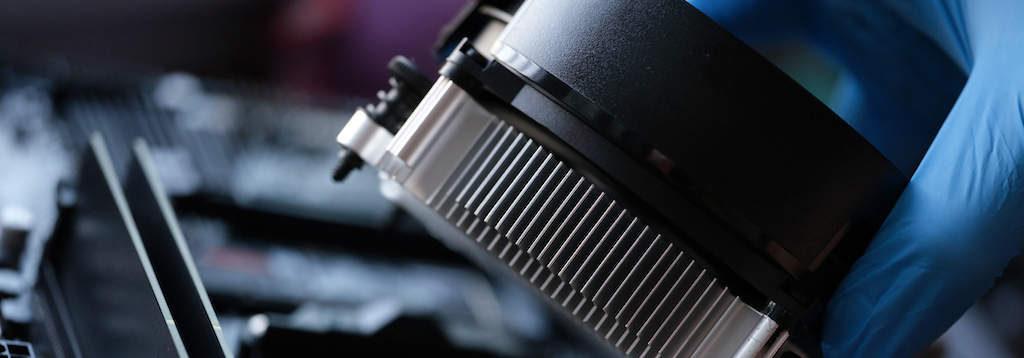 Closeup of cooler for cooling video card in hands of repairman